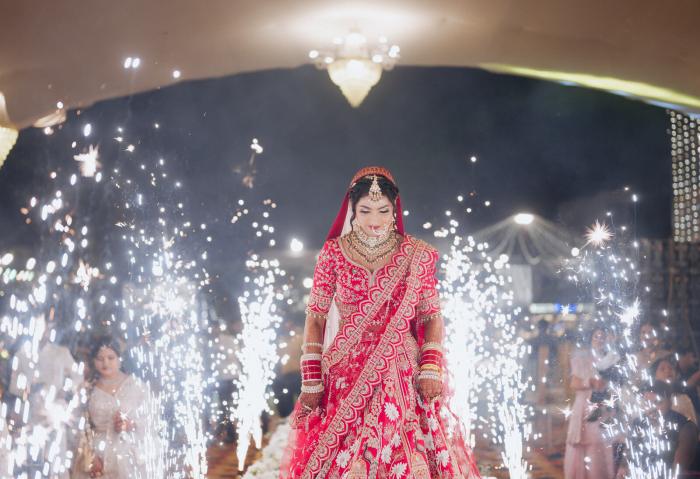 Bride walking in through sparkler fountains at her wedding entry, Prayagraj