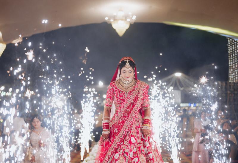 Bride walking in through sparkler fountains at her wedding entry, Prayagraj