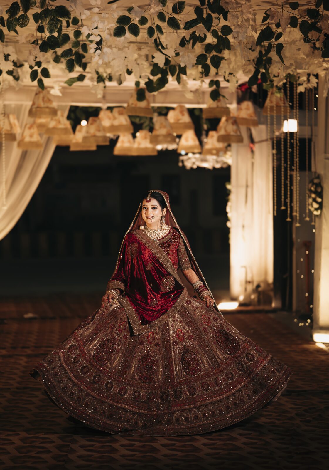 Bride twirling under a floral canopy at her wedding, Prayagraj