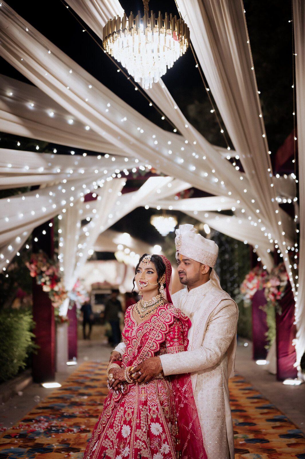 Bride and groom under a canopy of drapes and fairy lights, Prayagraj wedding