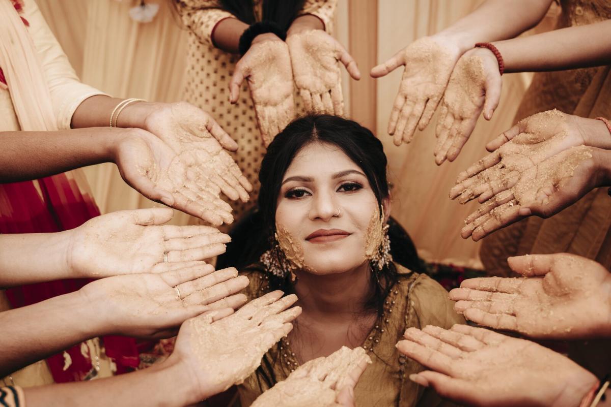 Family hands covered in haldi during the haldi ceremony, Prayagraj wedding