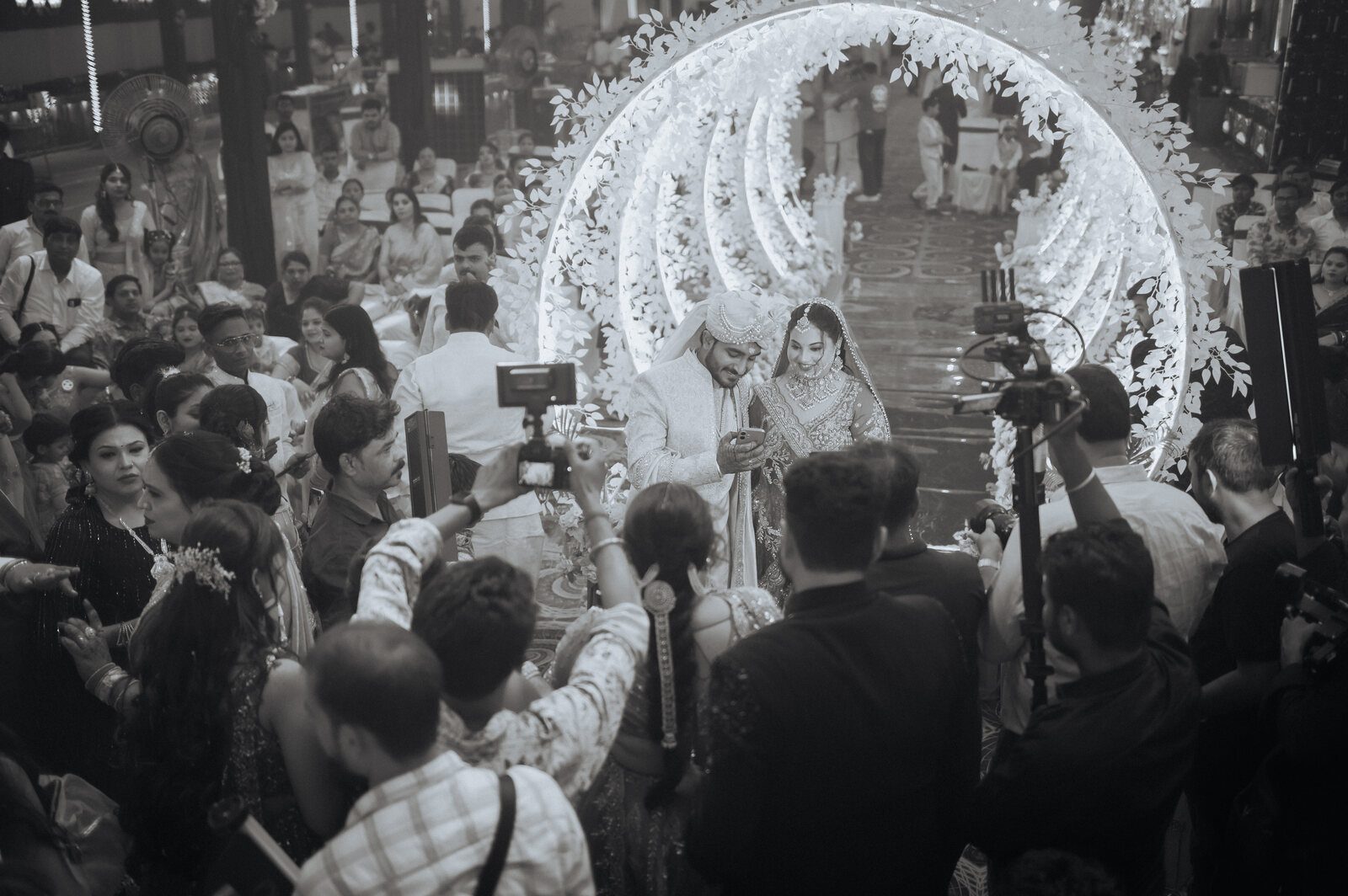 Jaimala moment under the lit mandap, candid wedding photography in Prayagraj
