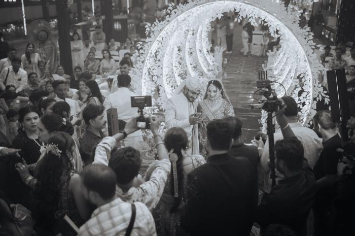 Jaimala moment under the lit mandap, candid wedding photography in Prayagraj
