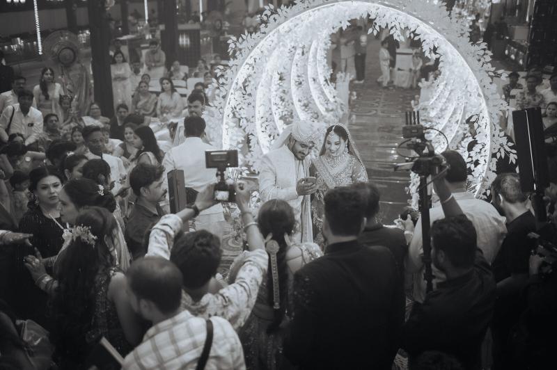 Jaimala moment under the lit mandap, candid wedding photography in Prayagraj