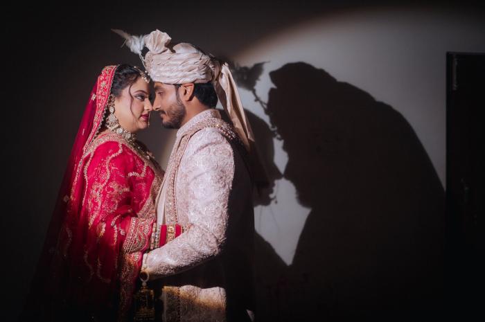 Bride and groom close together with their shadow on the wall, Prayagraj