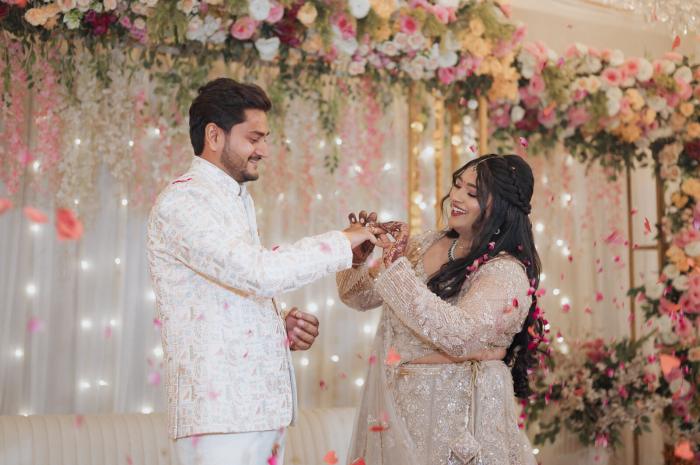 Ring ceremony under the floral backdrop, Prayagraj wedding