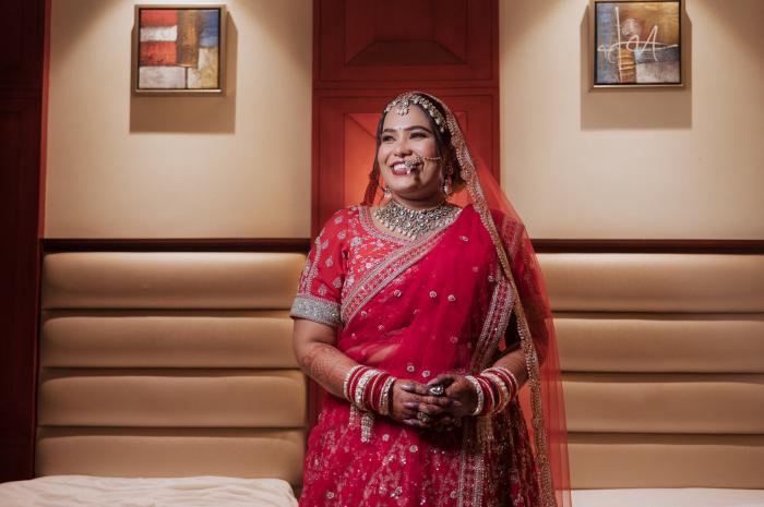 Bride in red waiting before the ceremony, Prayagraj wedding