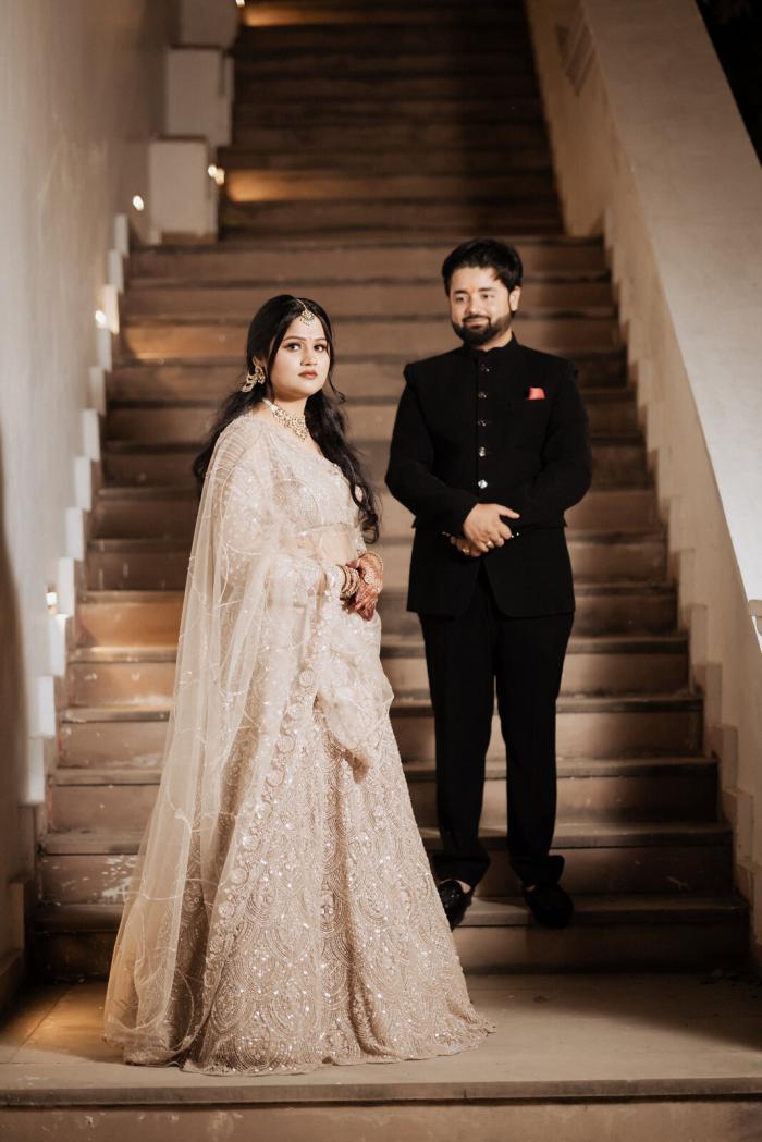 Bride and groom on the hotel staircase, Prayagraj wedding photography