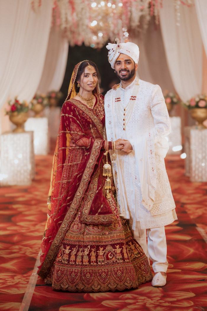 Bride and groom in red and ivory on their wedding day, Prayagraj