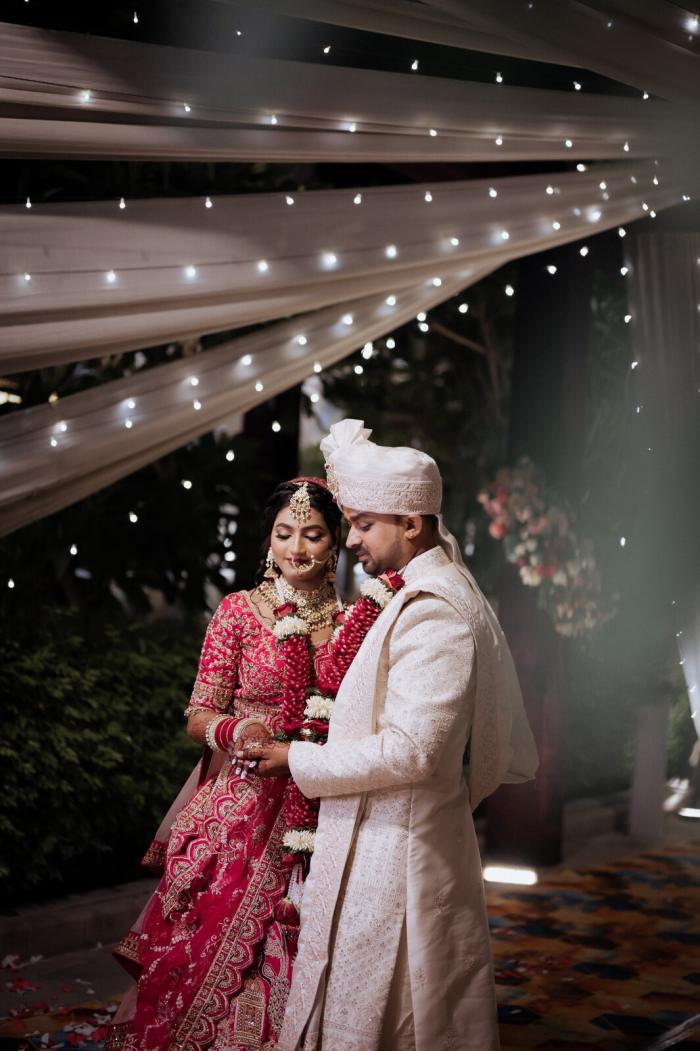Bride and groom under drapes and fairy lights, Prayagraj wedding