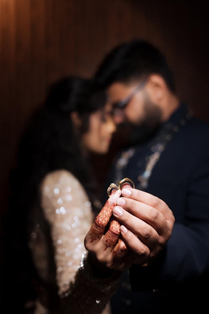 Exchanging rings in the low light, Prayagraj wedding
