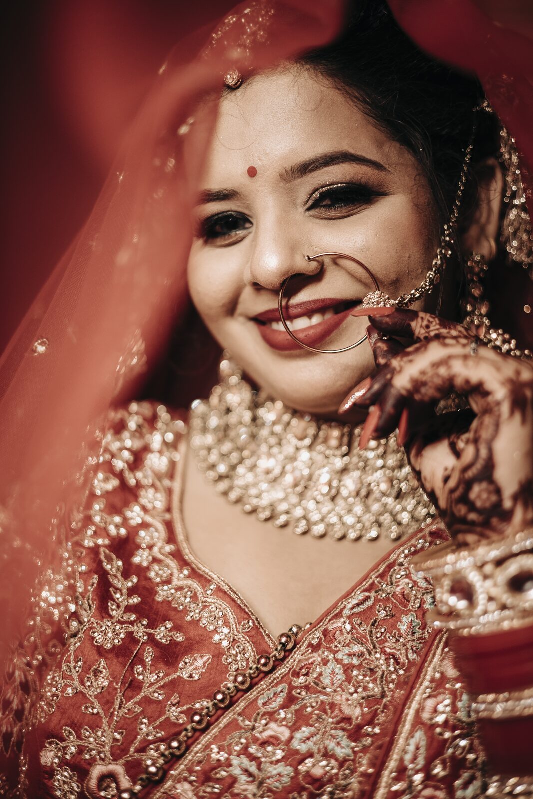 Smiling bride in red on her wedding day, photographed by PickYouPic Prayagraj
