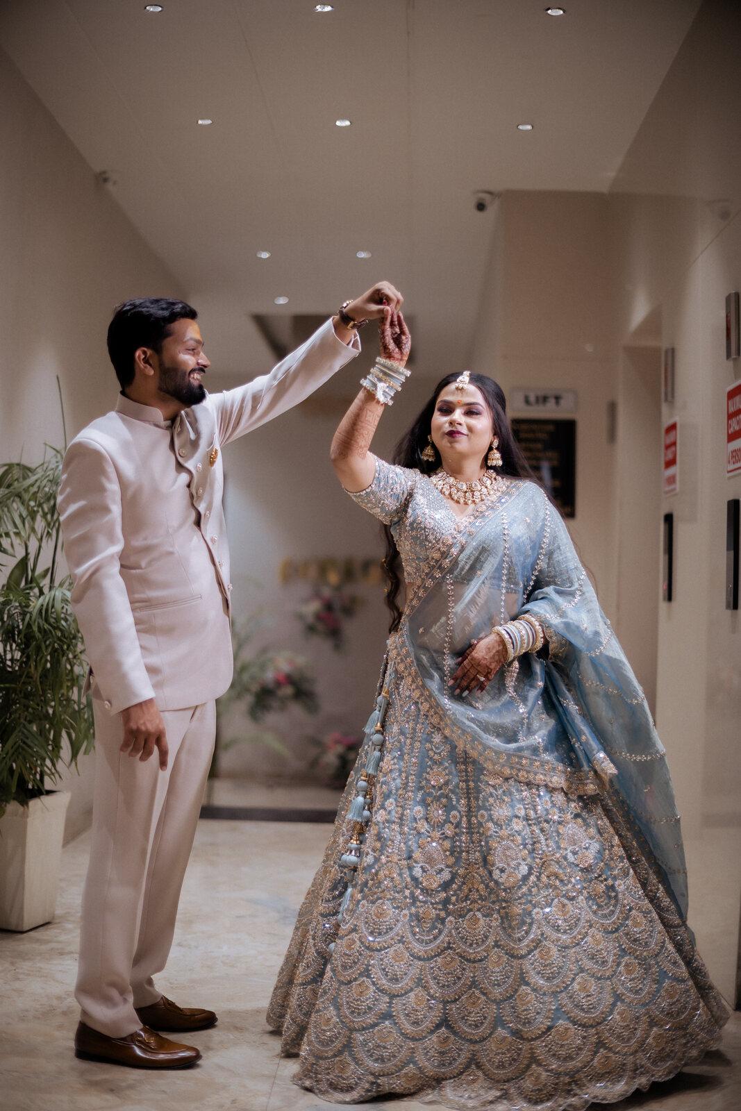 Groom twirling his bride in the hotel corridor, Prayagraj wedding photography