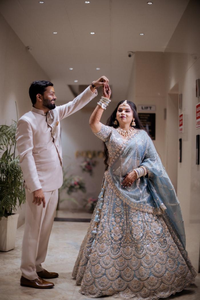 Groom twirling his bride in the hotel corridor, Prayagraj wedding photography