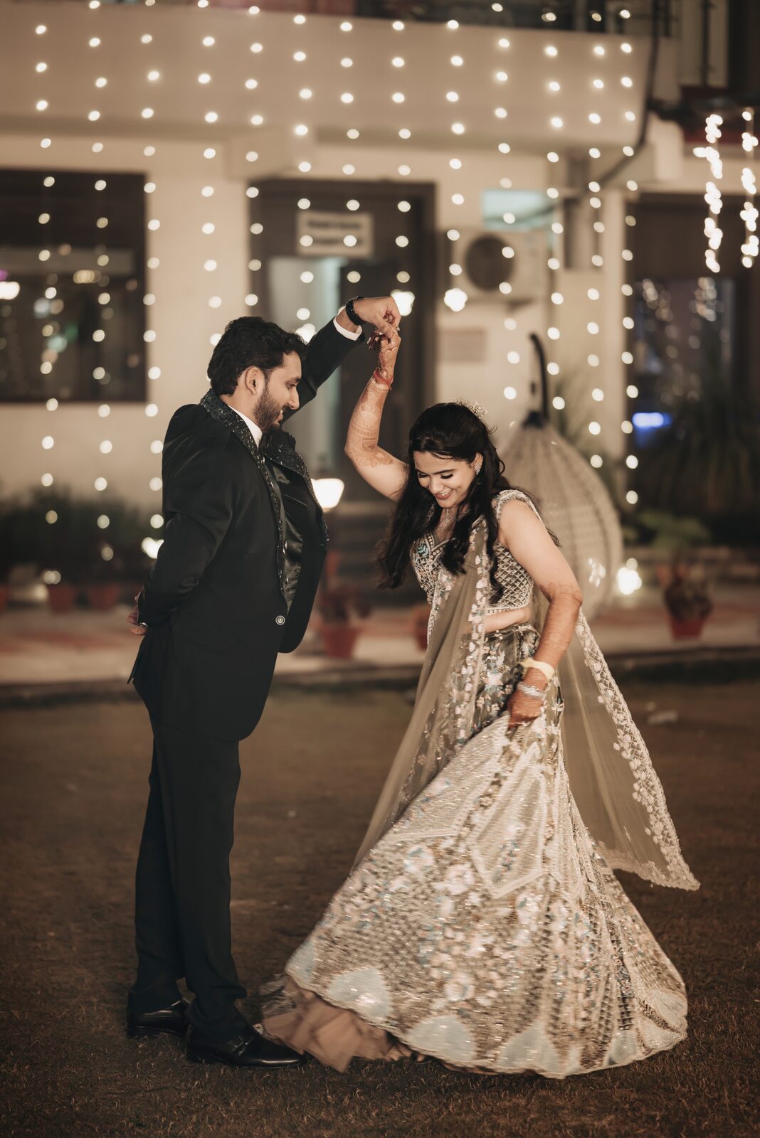 Bride and groom dancing together at their sangeet, Prayagraj