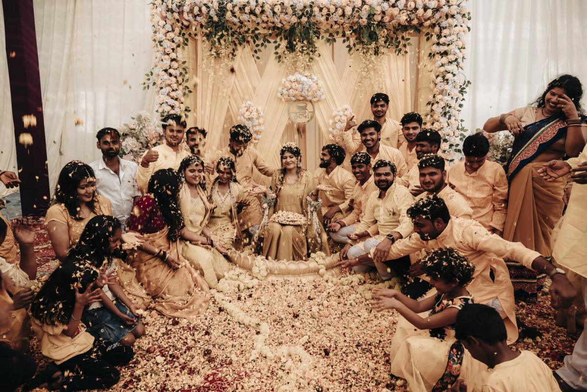 Family and friends covered in haldi during the ceremony, candid wedding photography