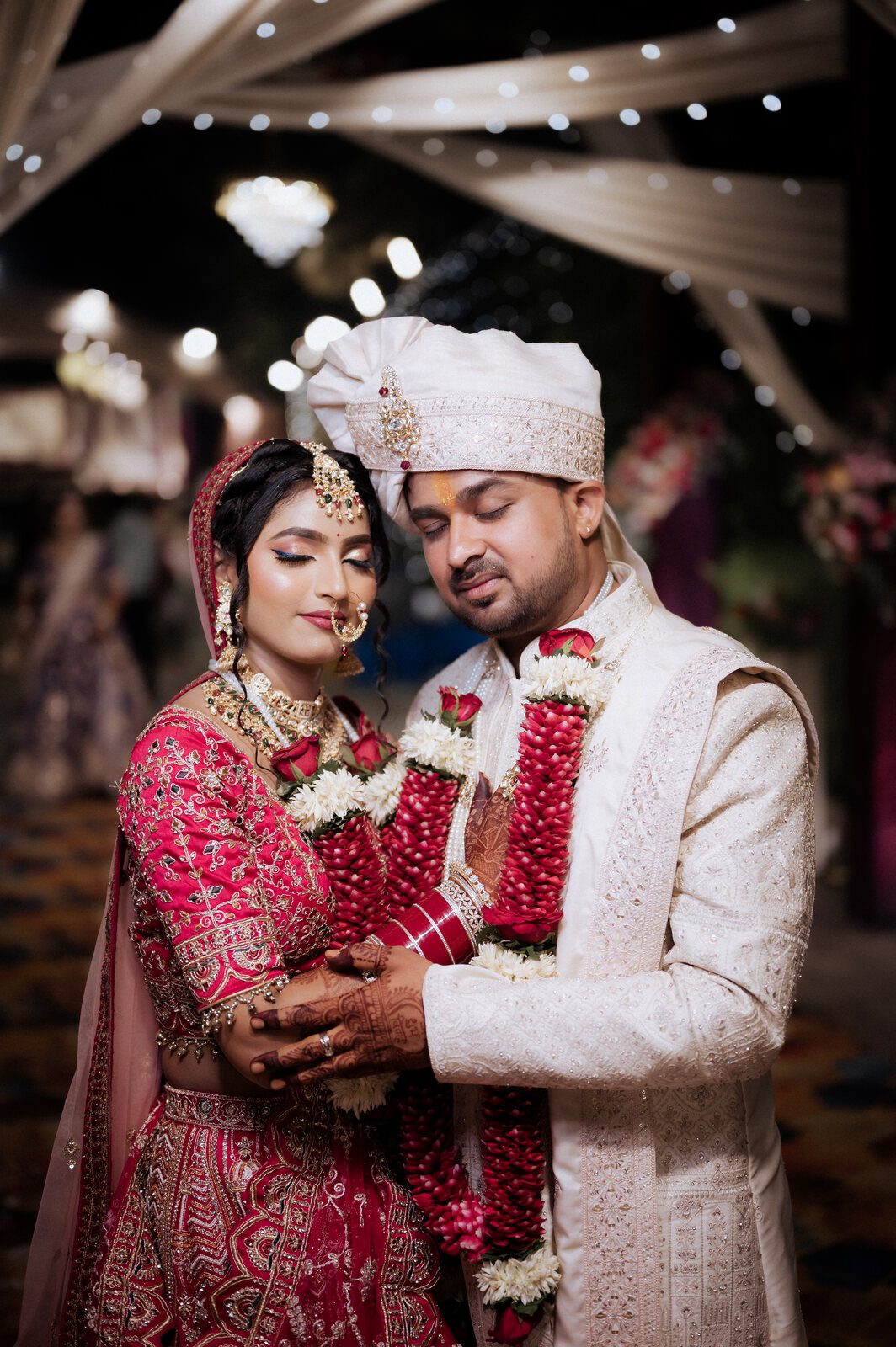 Bride and groom in their jaimala garlands under the fairy lights, Prayagraj