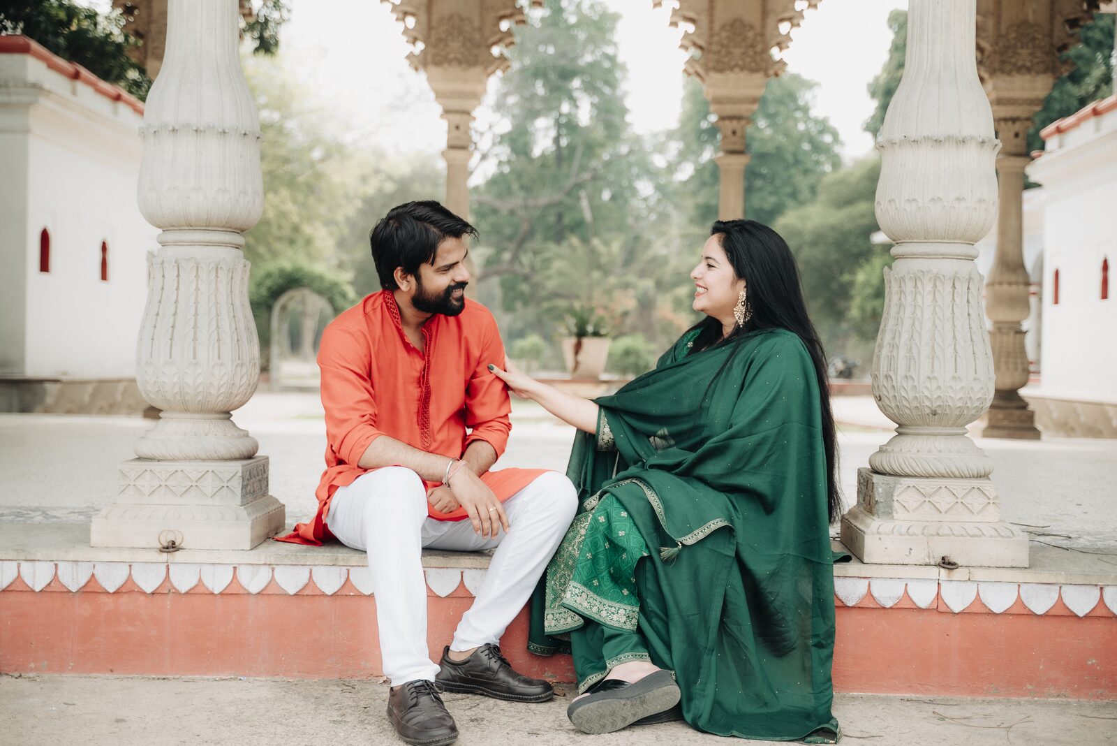 Couple at the pillars of a riverside temple, pre-wedding shoot location