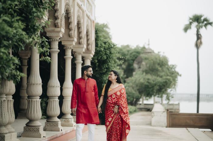 Couple by riverside pillars at sunset, pre-wedding shoot location in Prayagraj