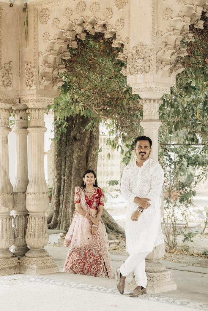 Couple framed by heritage arches and greenery, pre-wedding location