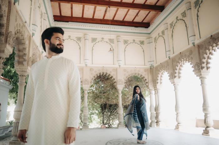 Couple inside a heritage hall with carved arches, pre-wedding location
