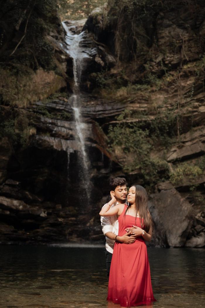 Couple standing in the pool at Bhalugaad Waterfall, Mukteshwar, on their pre-wedding shoot