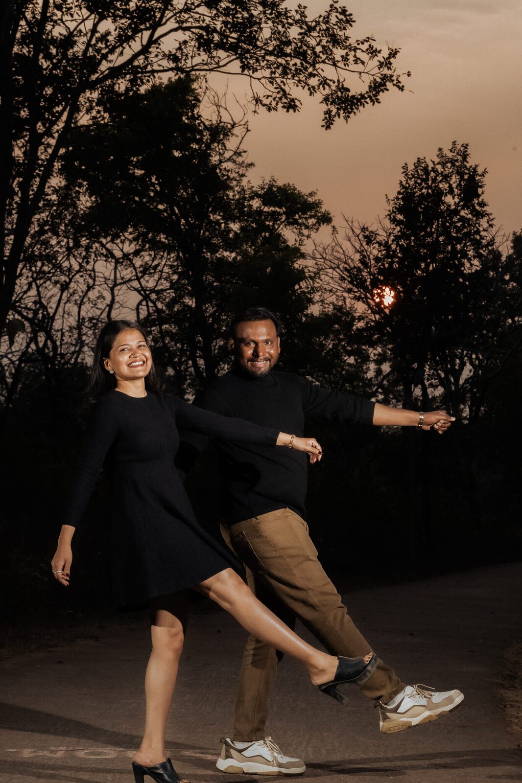 Couple dancing on the forest road at dusk in Dharkundi