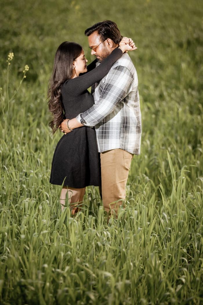 Couple embracing in a green wheat field near Dharkundi