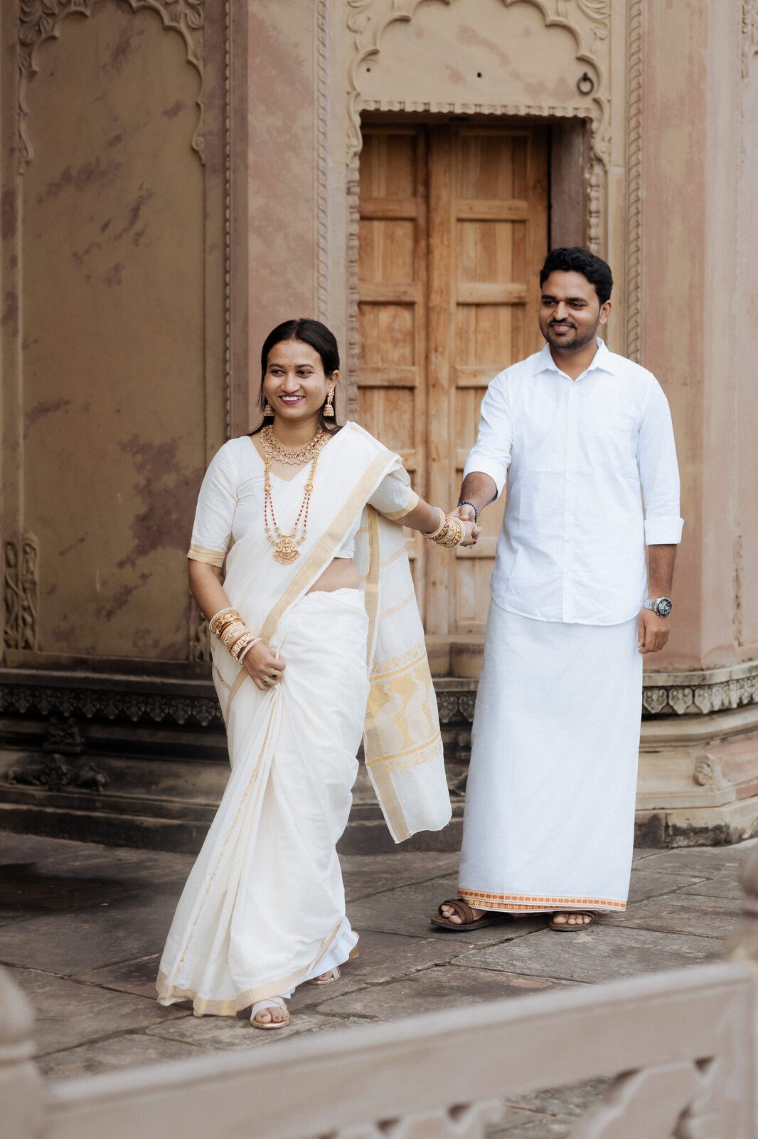 Pre-wedding portrait at a carved sandstone doorway, Ganesh Bagh Chitrakoot