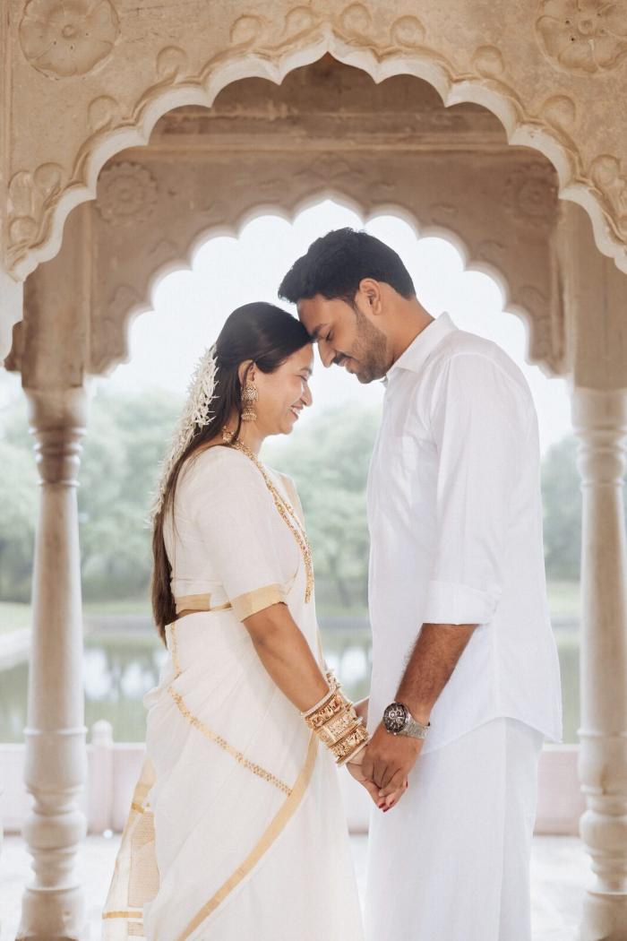 Forehead-to-forehead moment under an arch at Ganesh Bagh, Chitrakoot