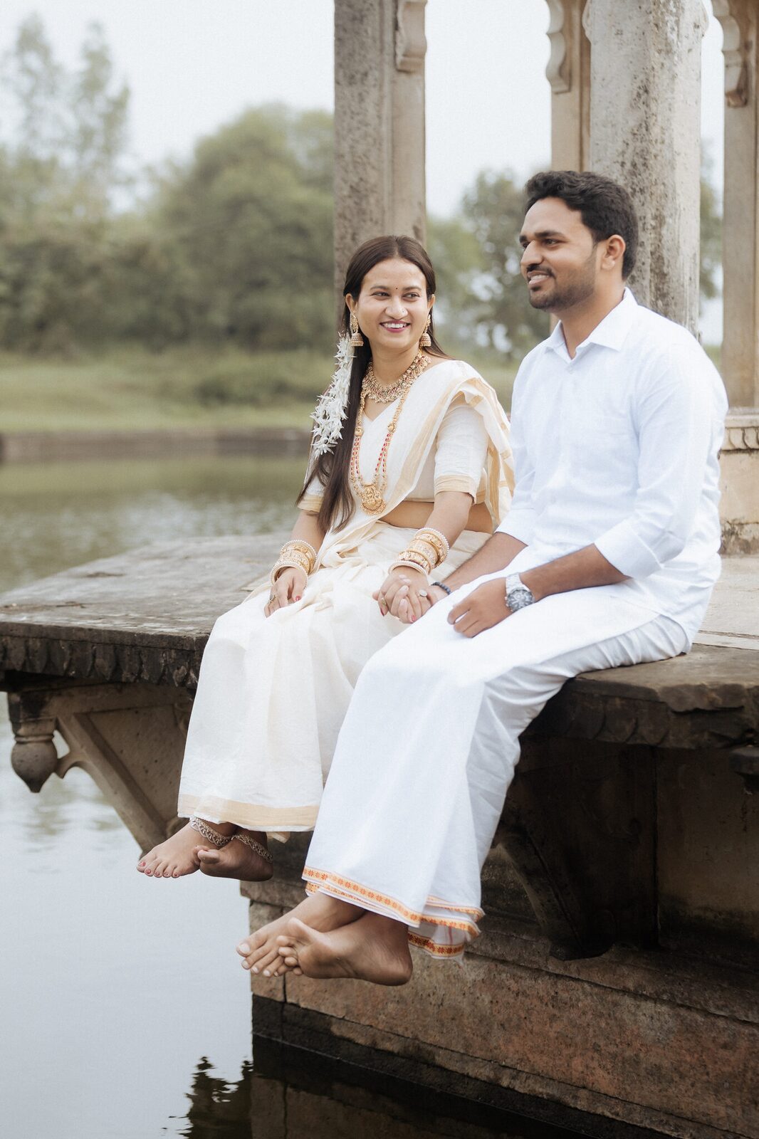 Sitting at the water's edge at Ganesh Bagh, Chitrakoot pre-wedding shoot
