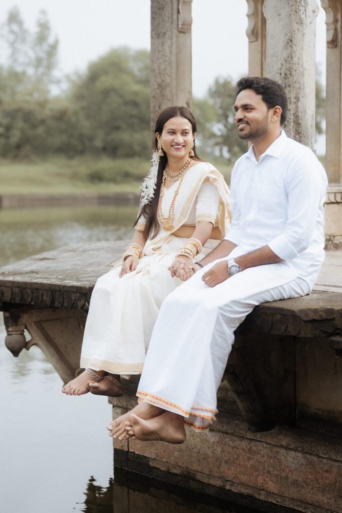 Sitting at the water's edge at Ganesh Bagh, Chitrakoot pre-wedding shoot