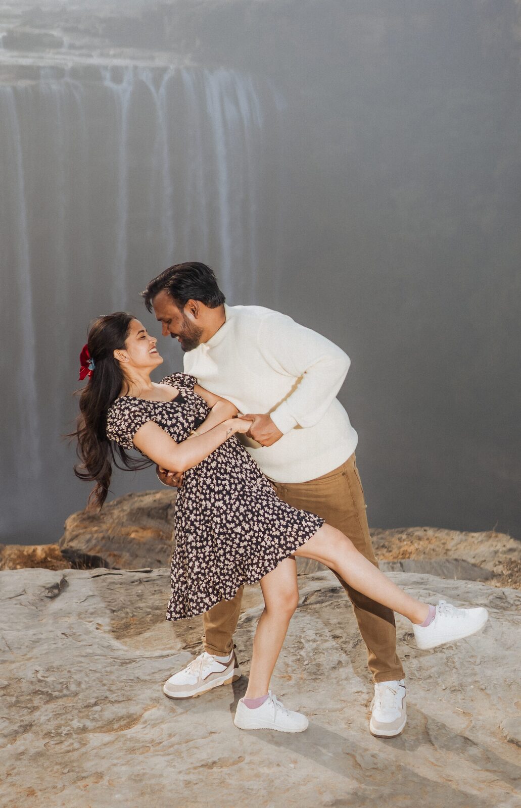 Couple at the cliff edge above Keoti Waterfall pre-wedding shoot