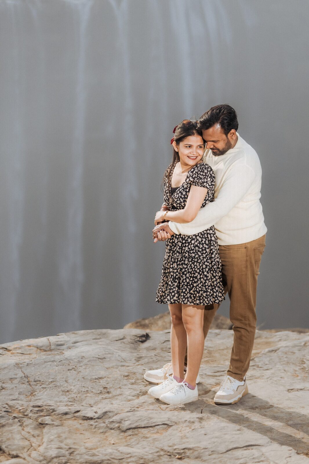 Quiet embrace with Keoti Waterfall behind, pre-wedding shoot