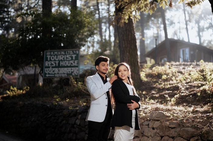 Couple outside the KMVN Tourist Rest House cottages in the pines, Nainital district