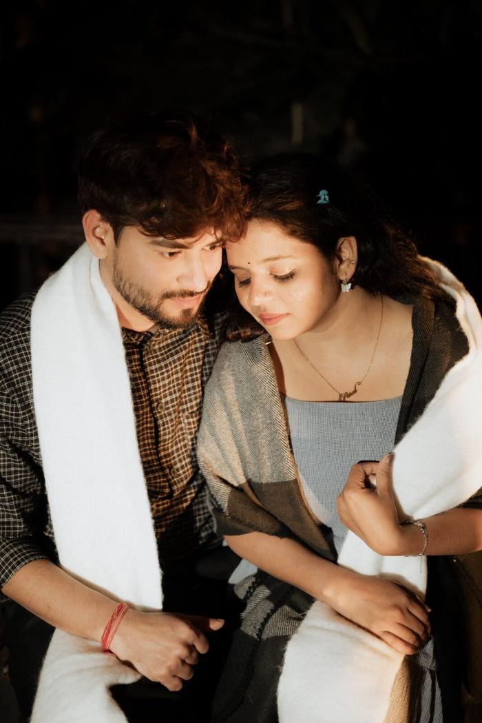 Couple wrapped in shawls beside a bonfire on a Nainital pre-wedding shoot