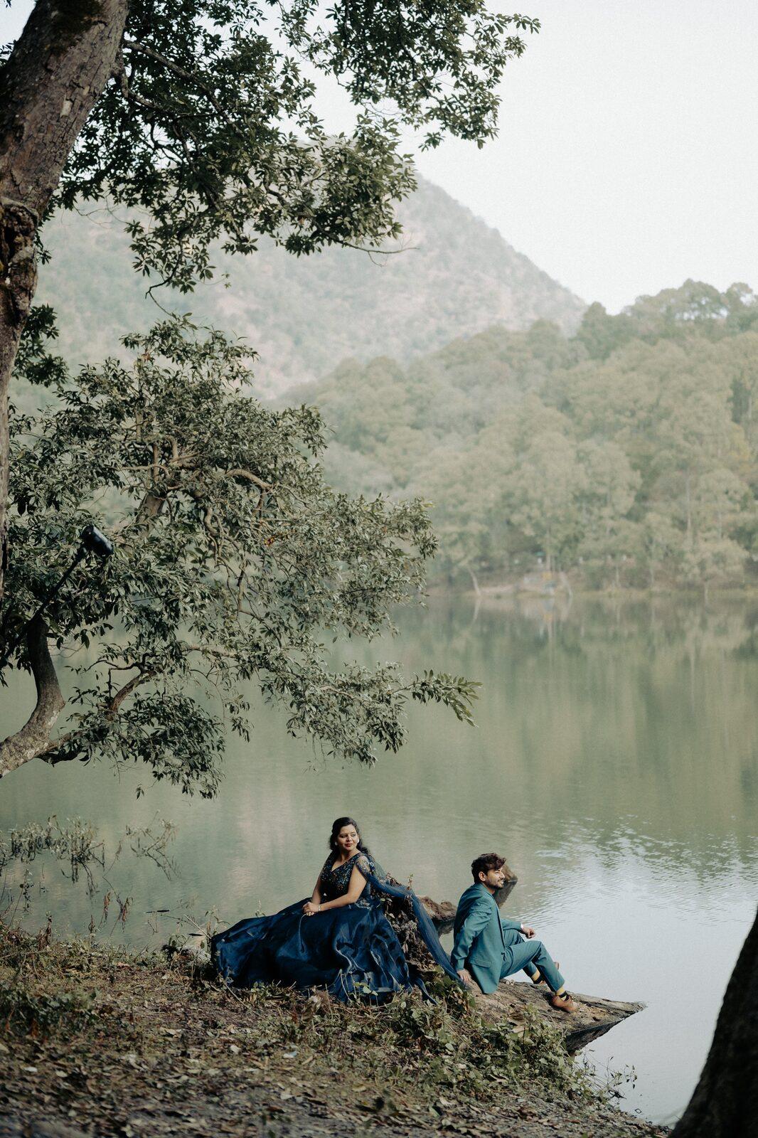Quiet lake with mirror reflections framing a pre-wedding portrait in Nainital