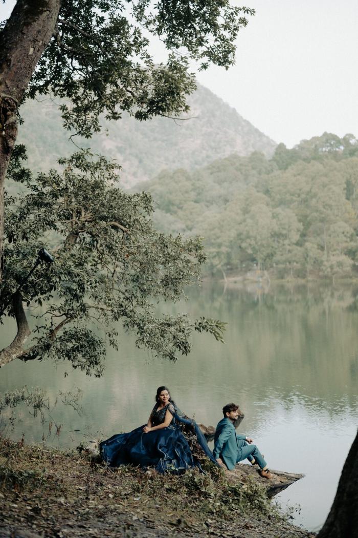 Quiet lake with mirror reflections framing a pre-wedding portrait in Nainital