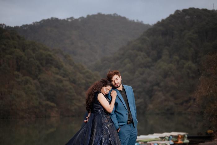 Couple embracing at Sattal Lake, Nainital, with forested hills in the background