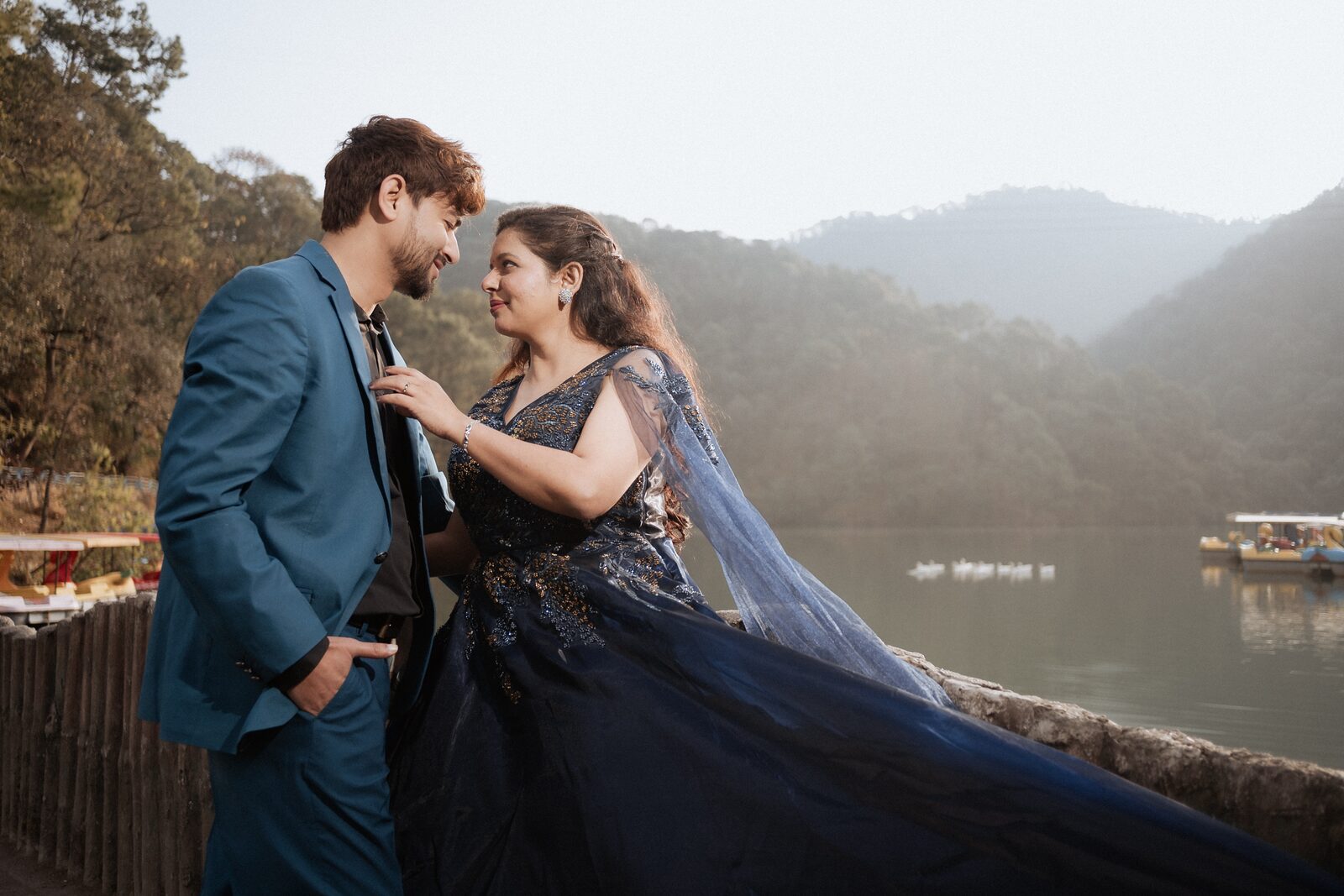 Pre-wedding shoot at Sattal Lake with the gown train spread out and misty hills behind