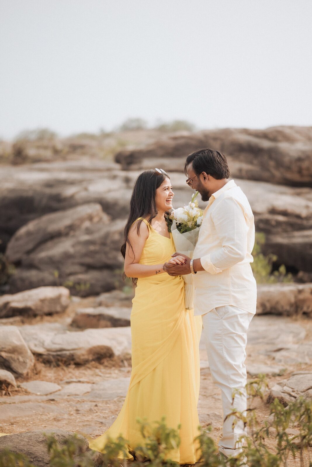 Couple with a bouquet on the rocks of Pabhosa hill, Kaushambi