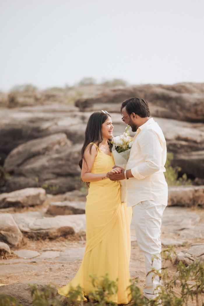 Couple with a bouquet on the rocks of Pabhosa hill, Kaushambi