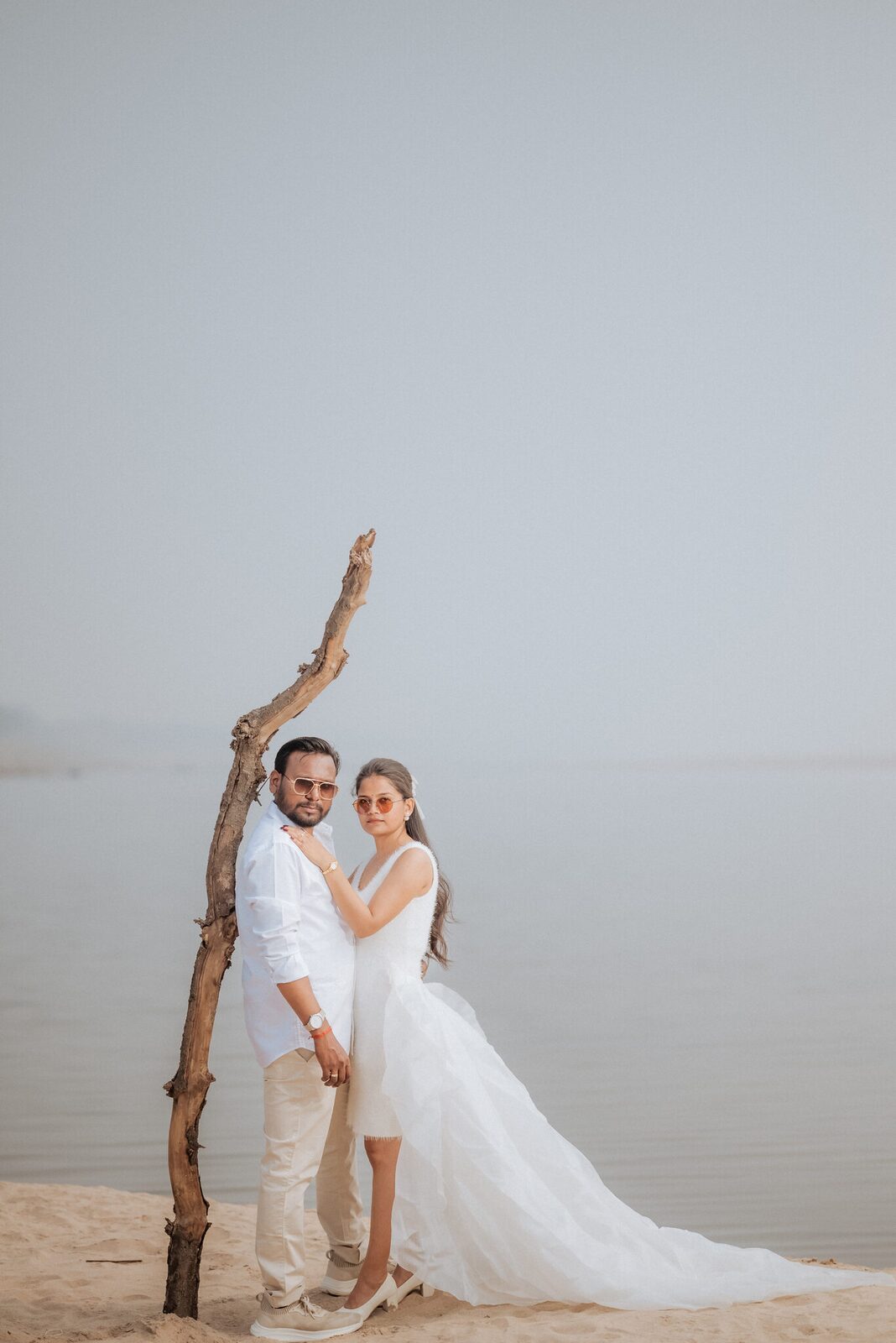 Couple beside driftwood on the Yamuna sandbank near Pabhosa