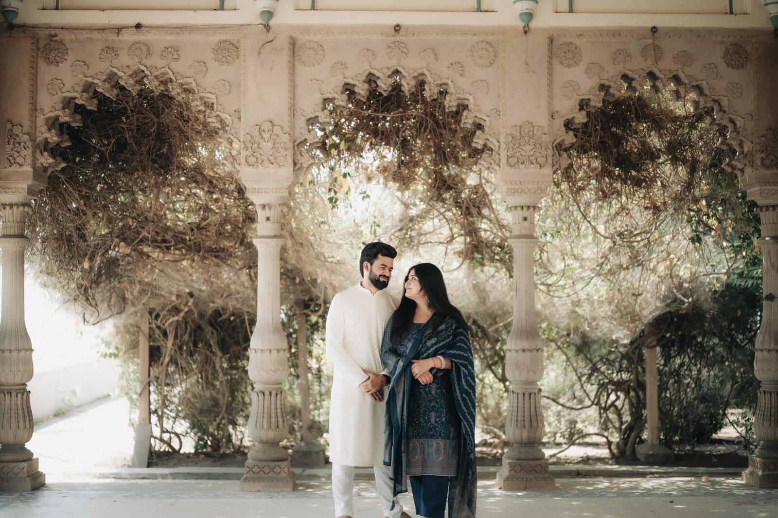 Couple in an arched heritage corridor during their pre-wedding shoot