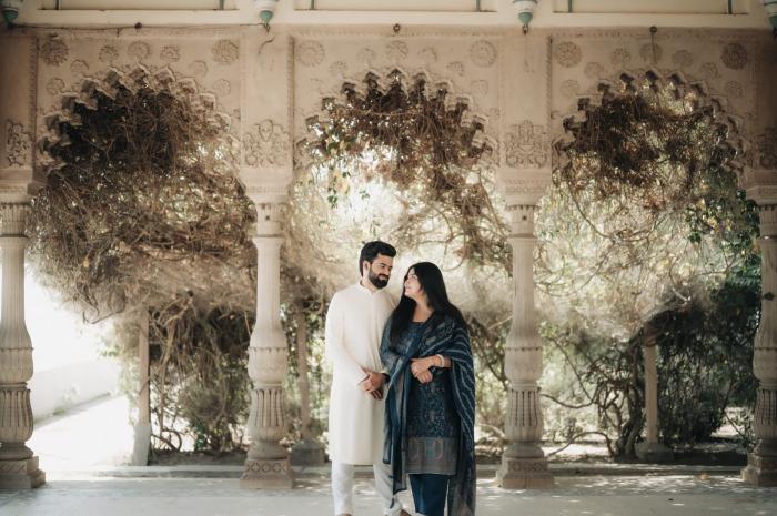 Couple in an arched heritage corridor during their pre-wedding shoot