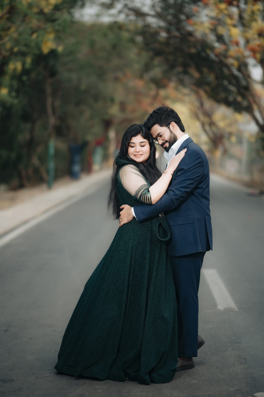 Couple embracing on a tree-lined road, pre-wedding photography by PickYouPic