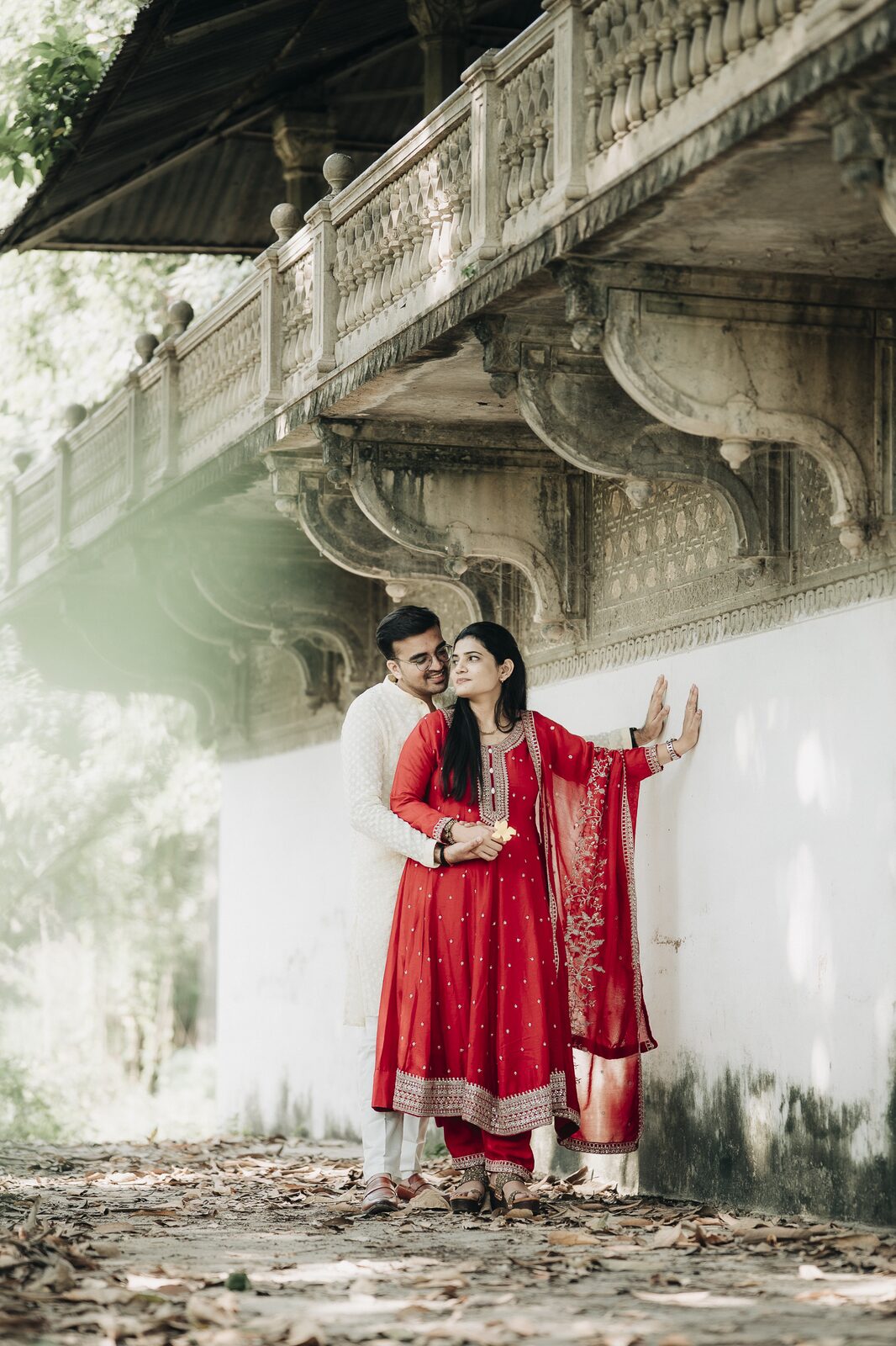 Couple posing under a river bridge during their pre-wedding shoot