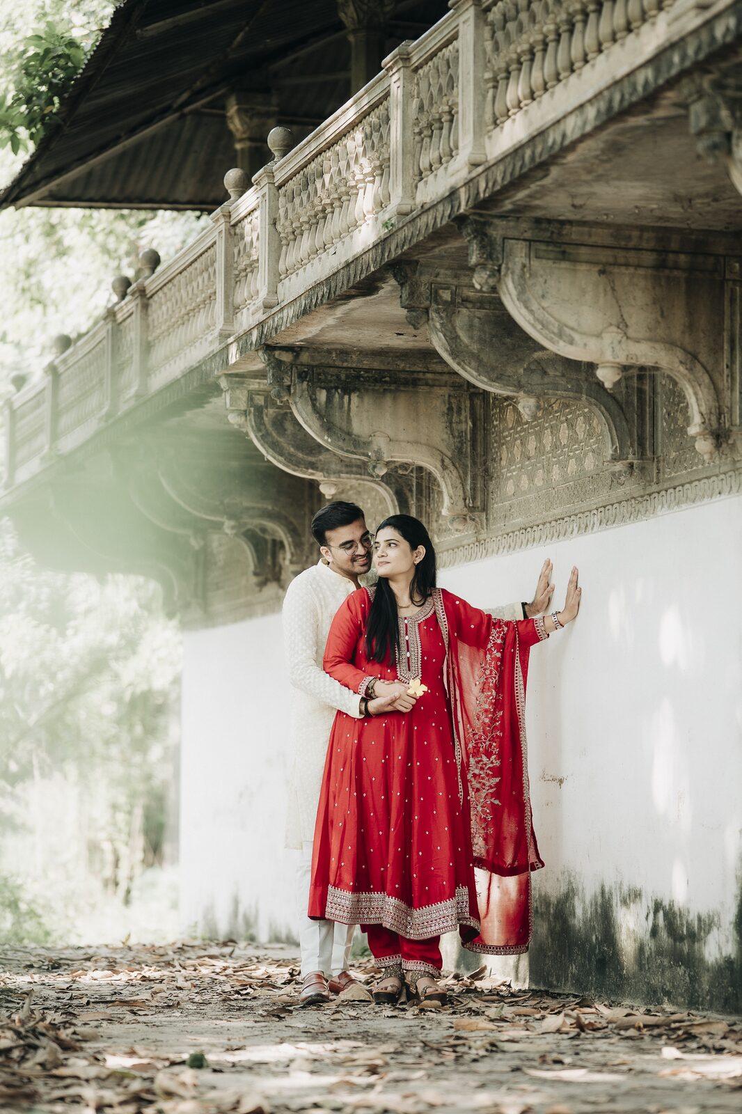 Couple posing under a river bridge during their pre-wedding shoot