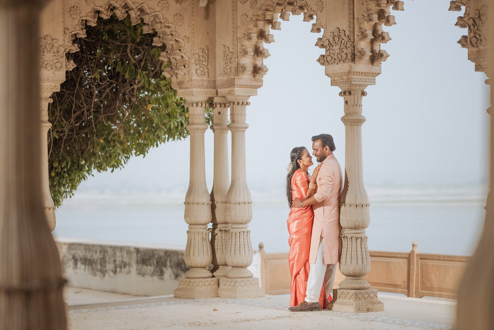 Couple in the carved sandstone arcade overlooking the river at Ram Bagiya, Prayagraj