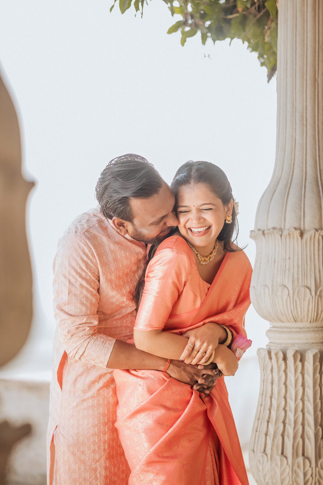 Couple embracing under a leafy arch at Ram Bagiya, Prayagraj